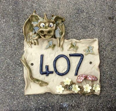 Dragon sitting on top of house number plaque