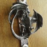 Flying dragon door knocker on wood door